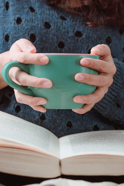 istock reading a book with cup of hot coffee 1254845359