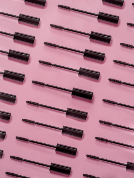 Brush rimmel pattern on  pink background Brush rimmel pattern on pink background mascara wands stock pictures, royalty-free photos & images