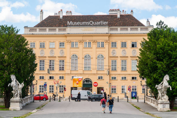 Close-up of Gutenberg statue and ornate Viennese baroque building with a classic café sign, ideal for editorial, cultural, and architectural content. Vienna, Austria, Apr. 10, 2025