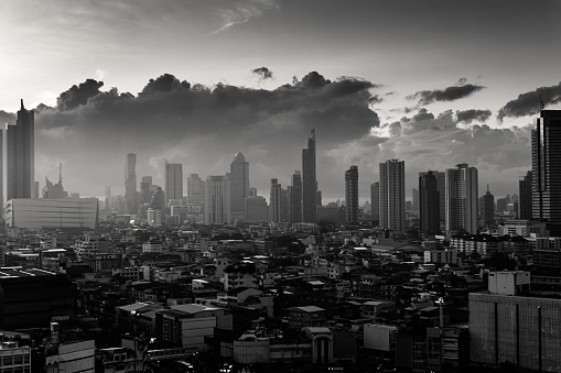 Bangkok city with high buildings in downtown and dramatic sky at dawn. Monochrome tone