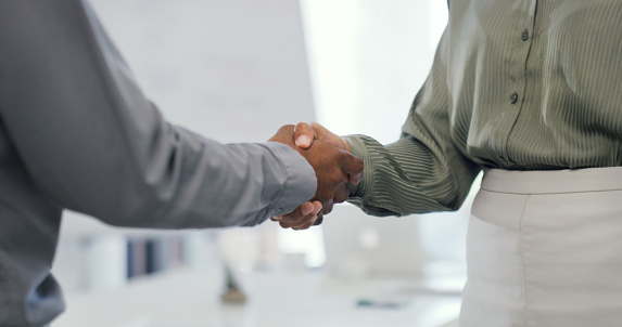 Cropped shot of two businesspeople shaking hands in an office