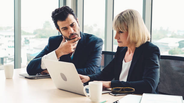 istock Two business people talk project strategy at office 1254849234