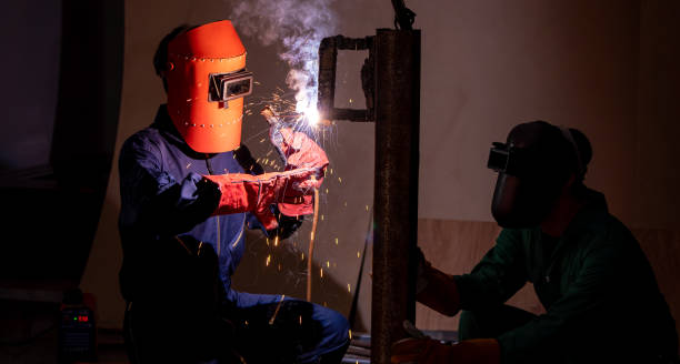 istock Metal welding steel works using electric arc welding machine 1254851375