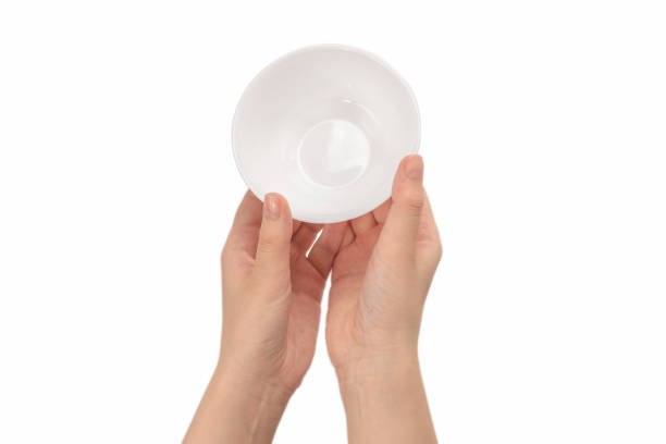 istock White bowl in woman hand isolated on white. 1254852755