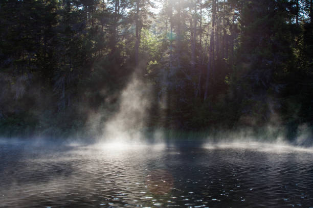 Fog above the lake at cold autumn morning.
