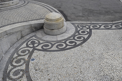 Portuguese mosaic in sidewalk. Cobblestone public floor