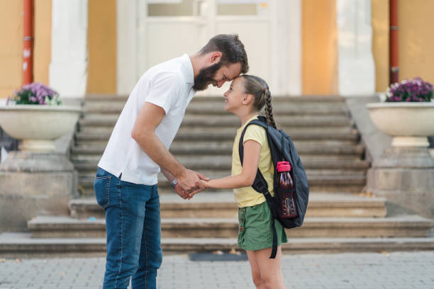 istock Father taking the kids to school 1254856907