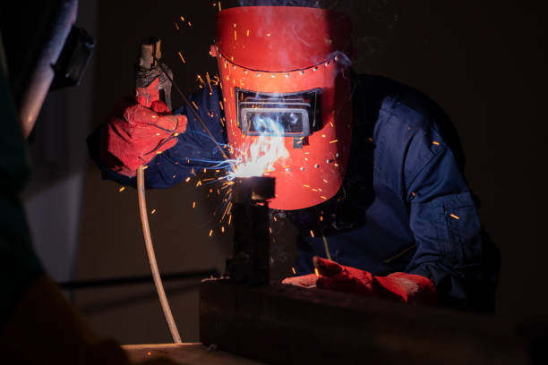 istock Metal welding steel works using electric arc welding machine 1254858343
