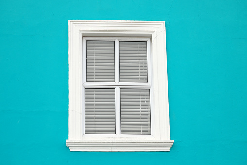 White window on blue wall
