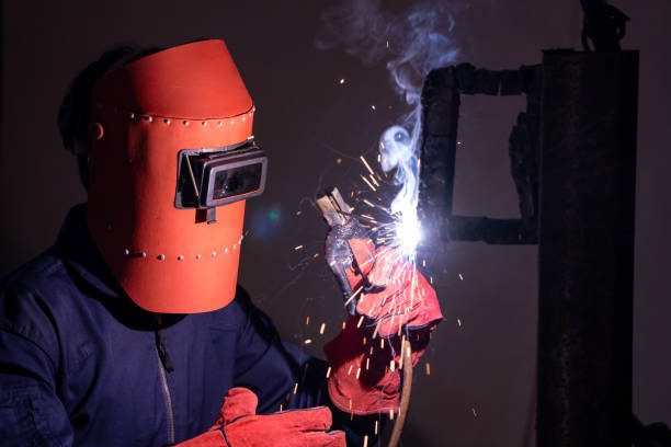 istock Metal welding steel works using electric arc welding machine 1254862353