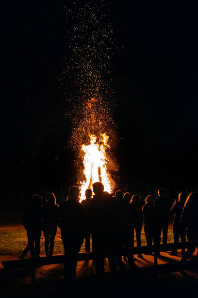 Photo of A lot of people have a night fire in the summer vertical