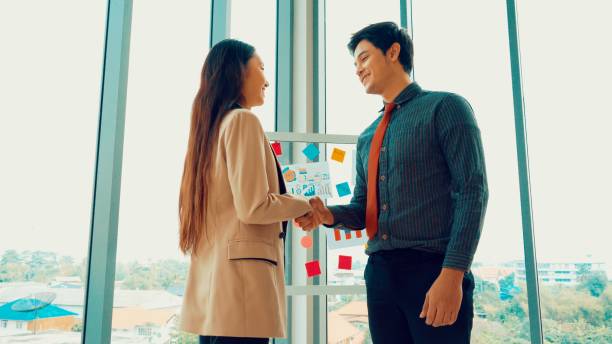 istock Business people handshake in corporate office 1254864039