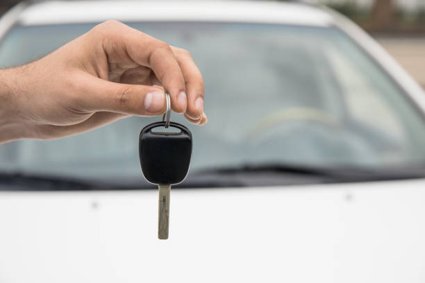 istock man hand key with car 1254864078
