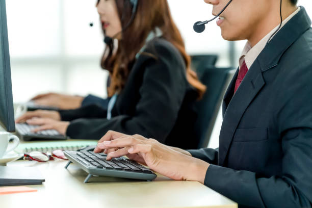 istock Business people wearing headset working in office 1254865627
