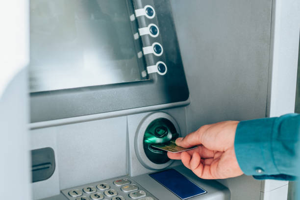 istock Man is withdrawing money from an ATM. 1254865650