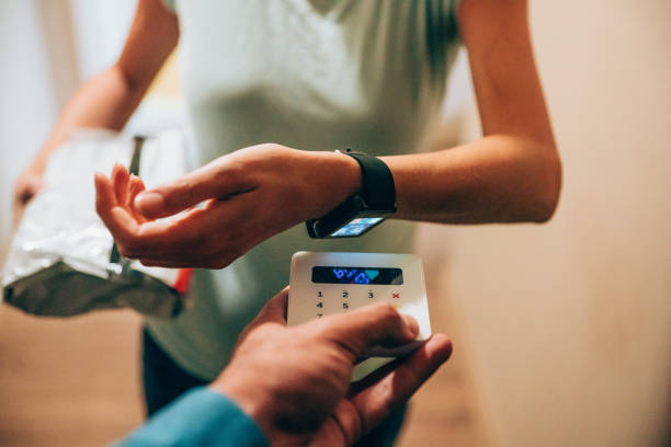 istock Woman paying contactless with smartwatch 1254865675