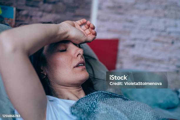 Woman With High Fever At Home Stock Photo - Download Image Now - Exhaustion, Fever, Illness