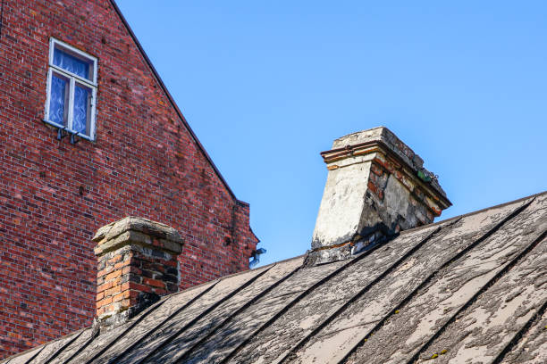 istock damaged brick chimney, cracked and dangerously skewed 1254867195
