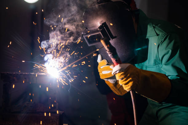 istock Metal welding steel works using electric arc welding machine 1254868112