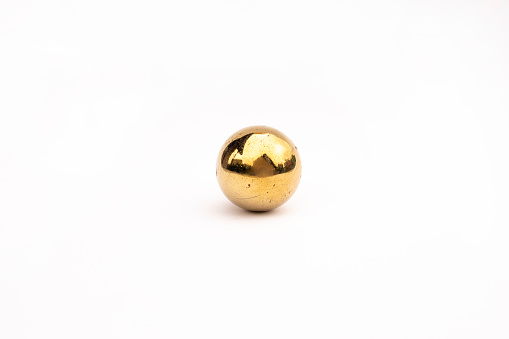 Golden scratched shiny ball isolated on clear white studio background