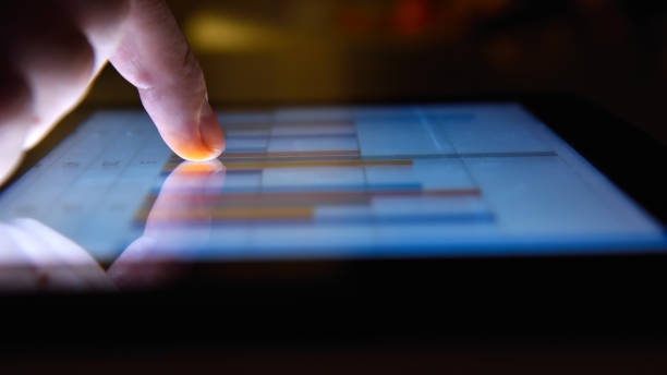 istock Businessman working in night office and using digital tablet 1254868520