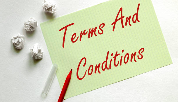 istock yellow paper with text Terms And Conditions on the white with red marker 1254869842