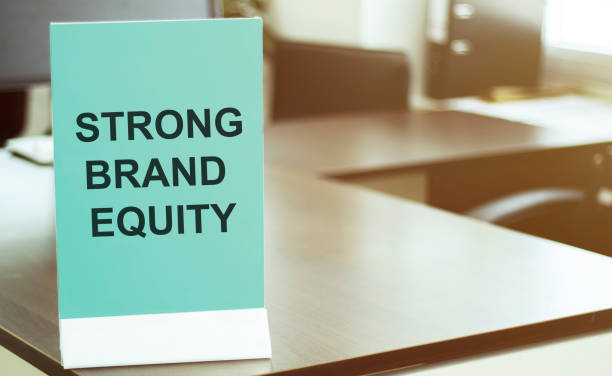istock blue board with text STRONG BRAND EQUITY on the office background 1254869866