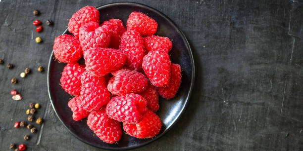 istock raspberry raw ripe red juicy berries Menu concept serving size. food background top view copy space organic healthy eating 1254870727