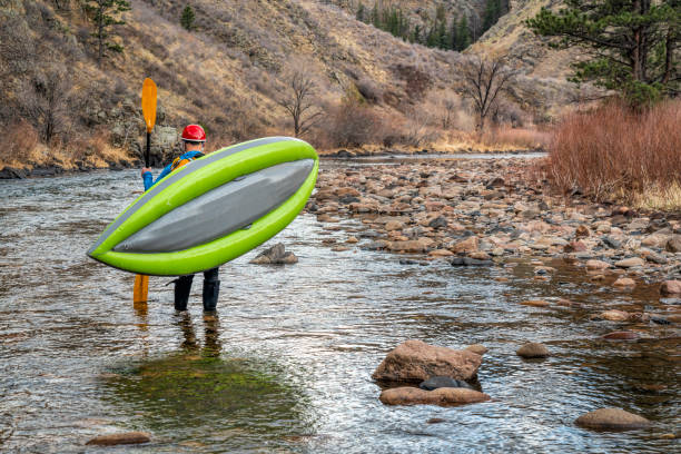 istock paddler carrying  inflatable whitewater kayak 1254870918