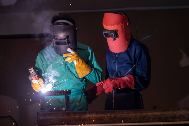 istock Metal welding steel works using electric arc welding machine 1254871710