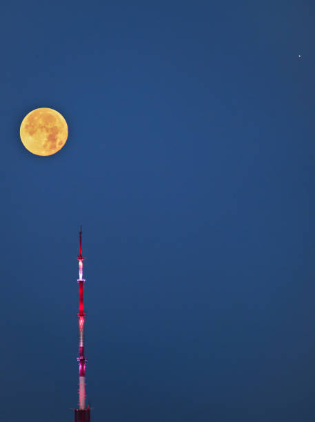 beautiful night sky on the city. the full moon onn the sky over the tv tower. - full moon audio imagens e fotografias de stock