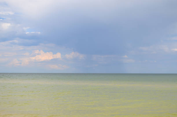 Calm azure sea and sky with clouds
