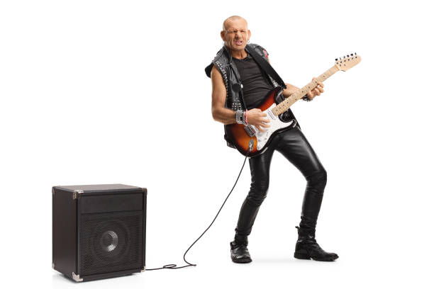 istock Bald musician playing a guitar plugged into an amplifier 1254872367