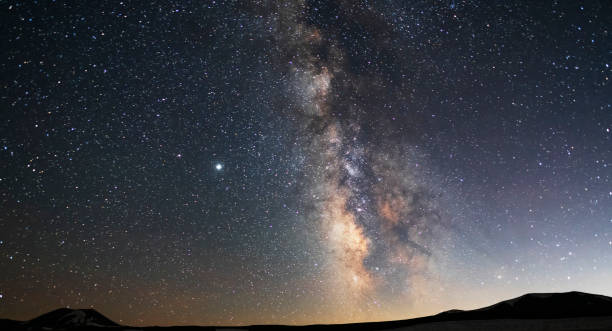 istock Beautiful starry sky with bright milky way galaxy. Night landscape. Astronomical background.  Night photography. 1254873142