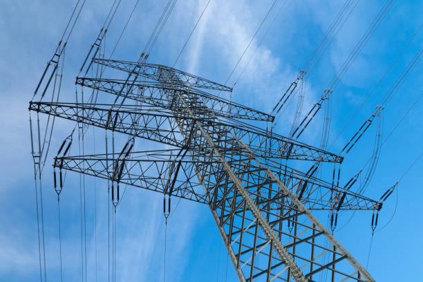 istock High voltage mast in front of blue sky with clouds 1254875138