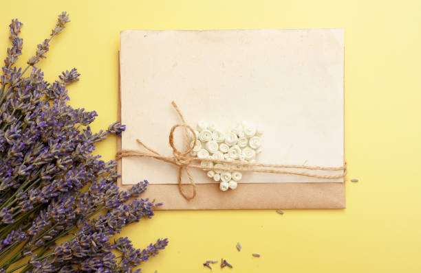 istock Flat lay empty sheet for text and lavender flowers on a yellow background. 1254876197