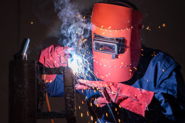 istock Metal welding steel works using electric arc welding machine 1254877145