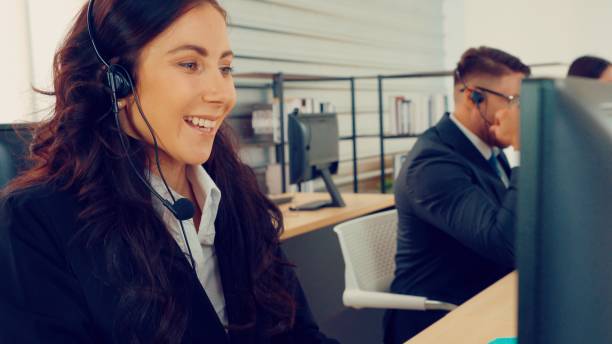 istock Business people wearing headset working in office 1254877411