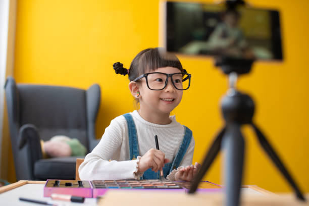 Little influencer teaching how to apply make-up for kids on live streaming video