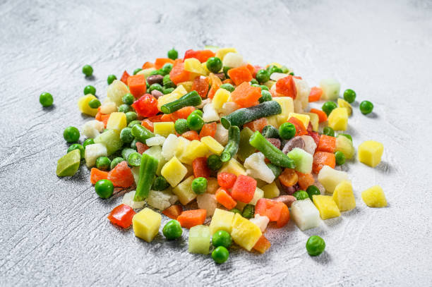 frozen vegetables. broccoli, cherry tomatoes, corn, pea, carrot.  white background. top view - edible mushroom frozen variation ice imagens e fotografias de stock