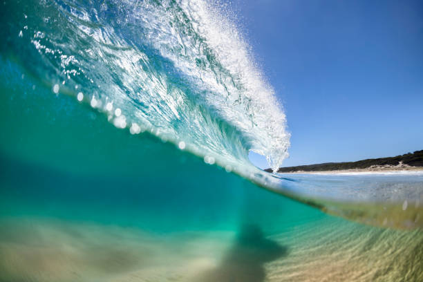 istock Splashing waves at sunrise 1254885899