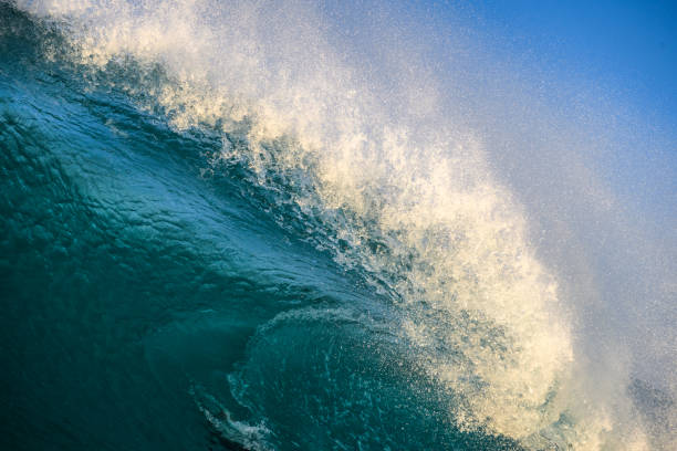 istock Splashing waves at sunrise 1254885940