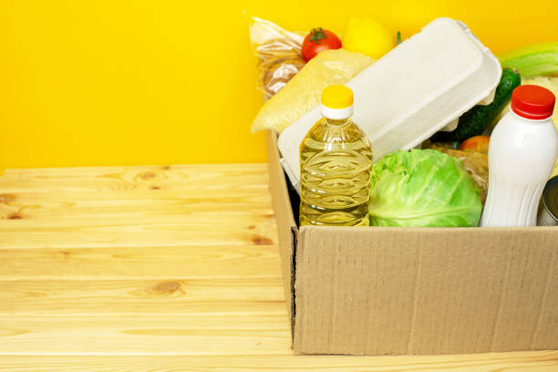 istock Various canned food, eggs and vegetables in a cardboard box. 1254886974
