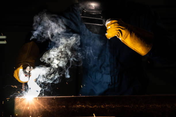 istock Metal welder working with arc welding machine. 1254888858