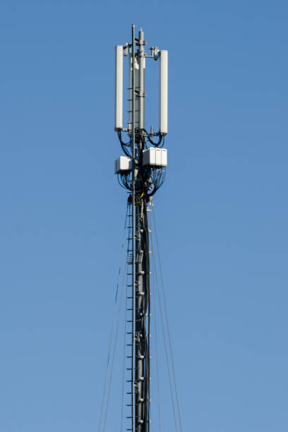 istock Telecommunication tower of 4G and 5G cellular. Cell Site Base Station. Wireless Communication Antenna Transmitter. Telecommunication tower with antennas against blue sky. 1254890572