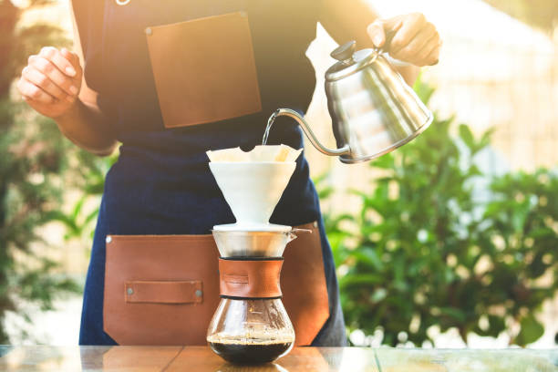 Drip coffee, barista pouring water on coffee ground with filter Drip coffee, barista pouring water on coffee ground with filter coffee filter stock pictures, royalty-free photos & images