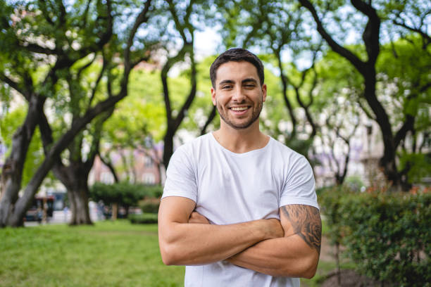 istock Cheerful young Hispanic man in a local park 1254890734