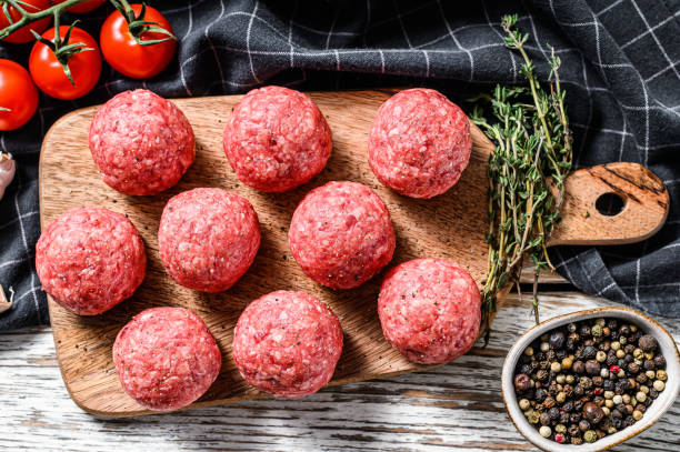 istock Raw meatballs, minced pork meat. White background. Top view 1254890772