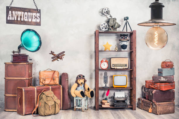 vintage travel suitcases, backpack, old gramophone, tv, radio, mic, projector, clock, typewriter, quill, books, camera, teddy bear, toy plane, signboard, mask. antiques collectibles. retro style photo - trunk luggage old fashioned retro revival imagens e fotografias de stock