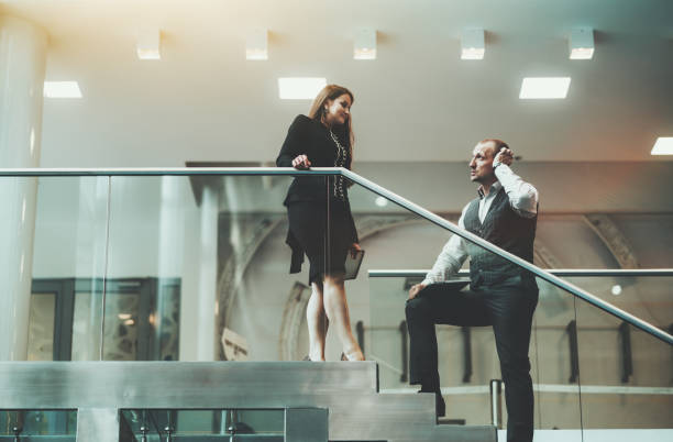 istock Business talk on office stairway 1254893625